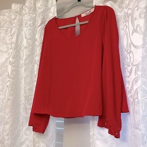 Red blouse with lace on wrist